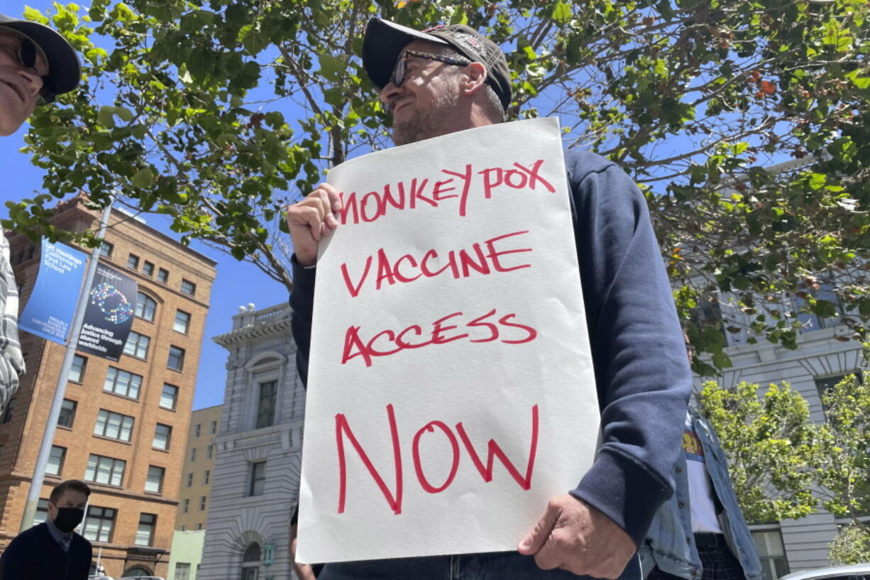 FILE - A man holds a sign urging increased access to the monkeypox vaccine during a protest in San Francisco on July 18, 2022. With monkeypox cases subsiding in Europe and parts of North America, many scientists say now is the time to prioritize stopping the virus in Africa.