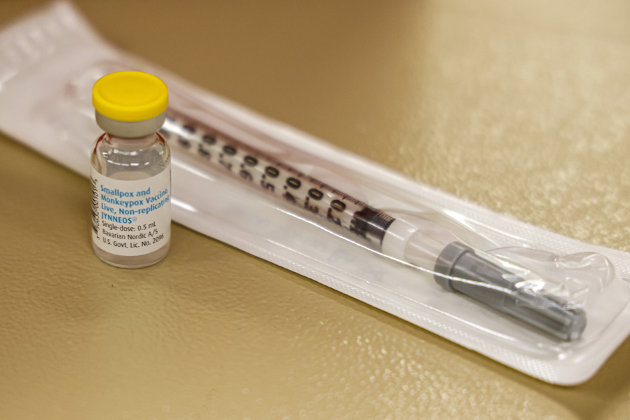 FILE - A vial containing the monkeypox vaccine and a syringe is set on the table at a vaccination clinic run by the Mecklenburg County Public Health Department in Charlotte, N.C., Saturday, Aug. 20, 2022. At-risk people who received just one dose of the monkeypox vaccine appeared to be significantly less likely to get sick from the virus, public health officials announced Wednesday, even as they urged a second dose for full protection.