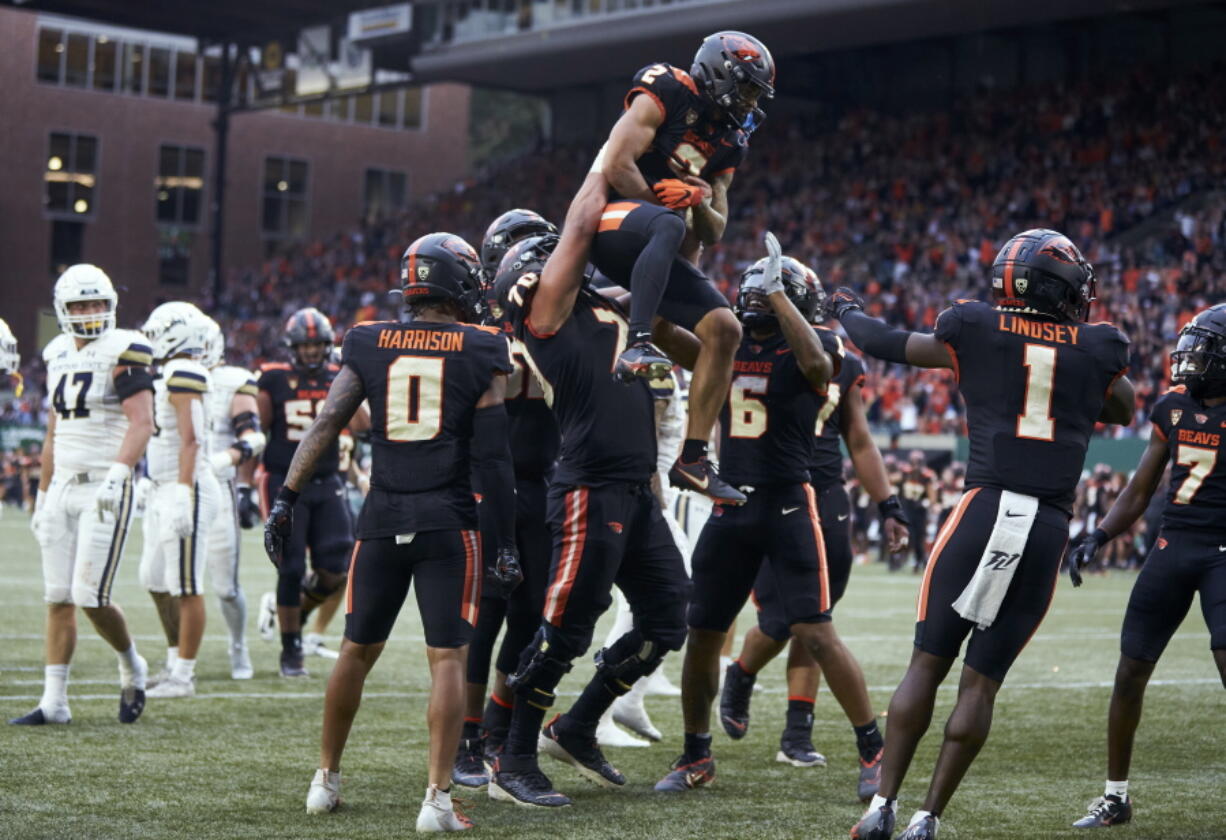 Oregon State wide receiver Anthony Gould is lifted by offensive lineman Jake Levengood after scoring a touchdown against Montana State during the first half of an NCAA college football game in Portland, Ore., Saturday, Sept. 17, 2022.