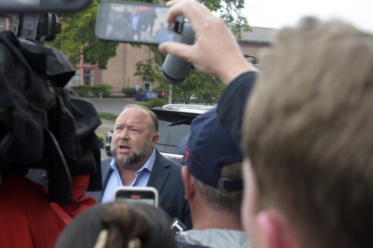 Alex Jones speaks with the media outside of Superior Court in Waterbury, Conn., on Thursday, Sept. 22, 2022.  Jones is going to take the stand to testify in a trial in Connecticut over how much in damages he must pay for calling the Sandy Hook school shooting a hoax.