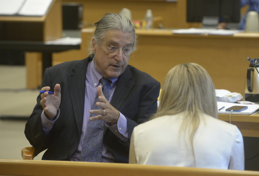 Norman Pattis, attorney for Alex Jones, in discussion with Brittany Paz, a Connecticut lawyer hired by Jones to testify about his companies' operations, during the Alex Jones Sandy Hook defamation damages trial in Superior Court in Waterbury, Conn.,, Friday, Sept. 16, 2022.
