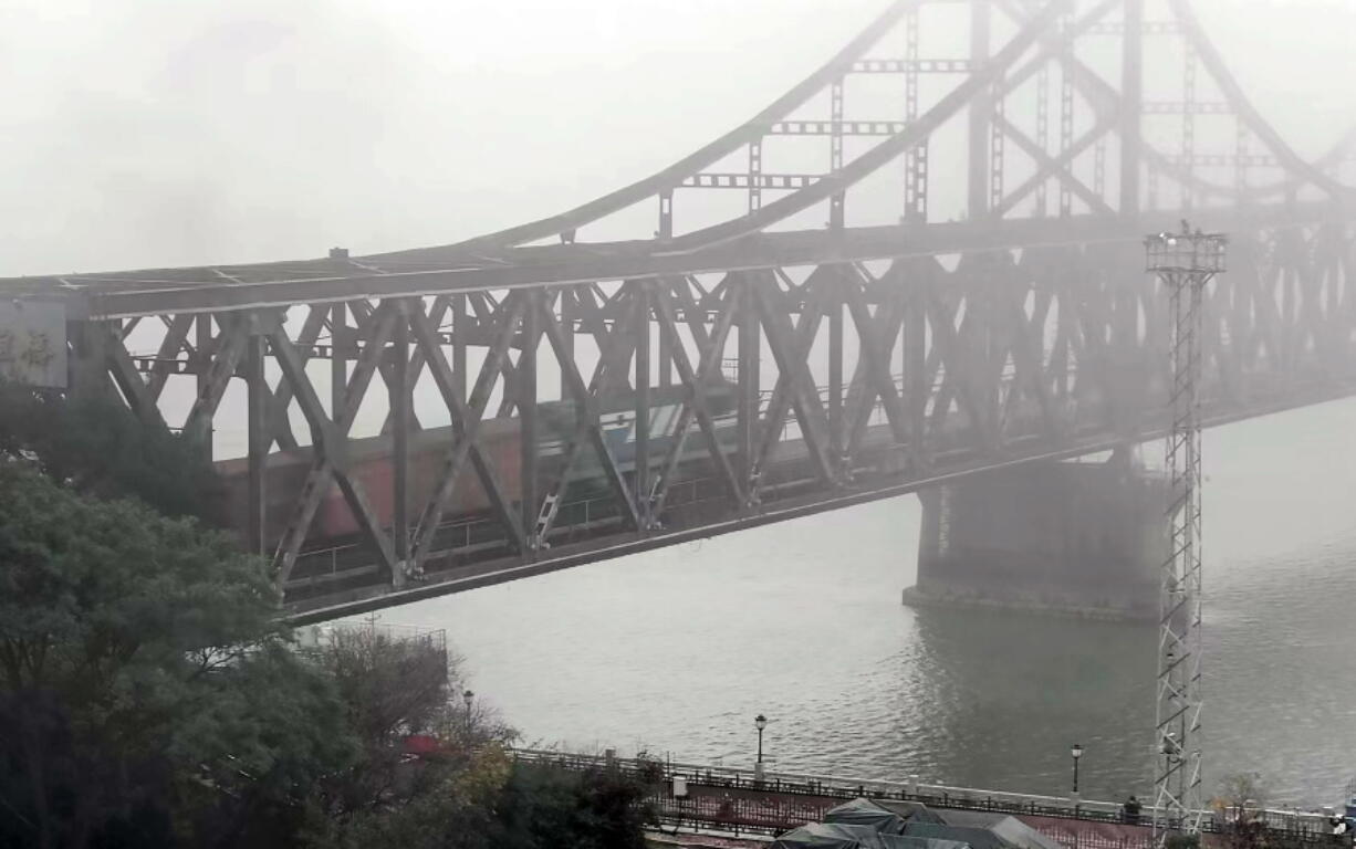 A freight train crosses a bridge connecting China and North Korea in Dandong in northeastern China's Liaoning province, Monday, Sept. 26, 2022. North Korea and China resumed freight train service Monday following a five-month hiatus, South Korean officials said, as the North struggles to revive an economy battered by the pandemic, U.N. sanctions and other factors.