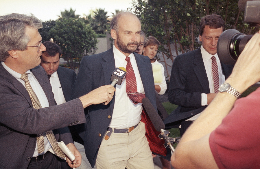 FILE - Former Exxon Valdez Capt. Joseph Hazelwood is surrounded by reporters as he leaves his re-licensing hearing in Long Beach, Calif., on July 25, 1990. Hazelwood, the captain of the Exxon Valdez oil tanker that ran aground more than three decades ago in Alaska, causing one of the worst oil spills in U.S. history, has died in July 2022, the New York Times reported. He was 75.