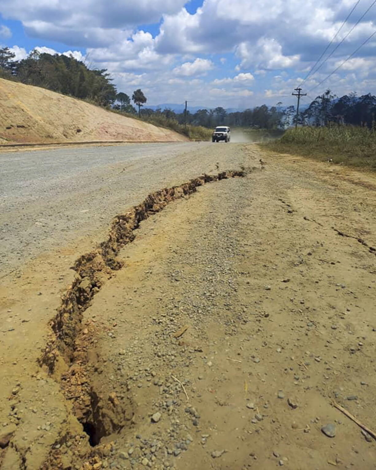 A large crack is seen in a highway near the town of Kainantu, following a 7.6-magnitude earthquake in northeastern Papua New Guinea, Sunday, Sept. 11, 2022. The quake hit at 9:46 a.m. local time, with the epicenter 67 kilometers (42 miles) east of Kainantu, a sparsely populated area.