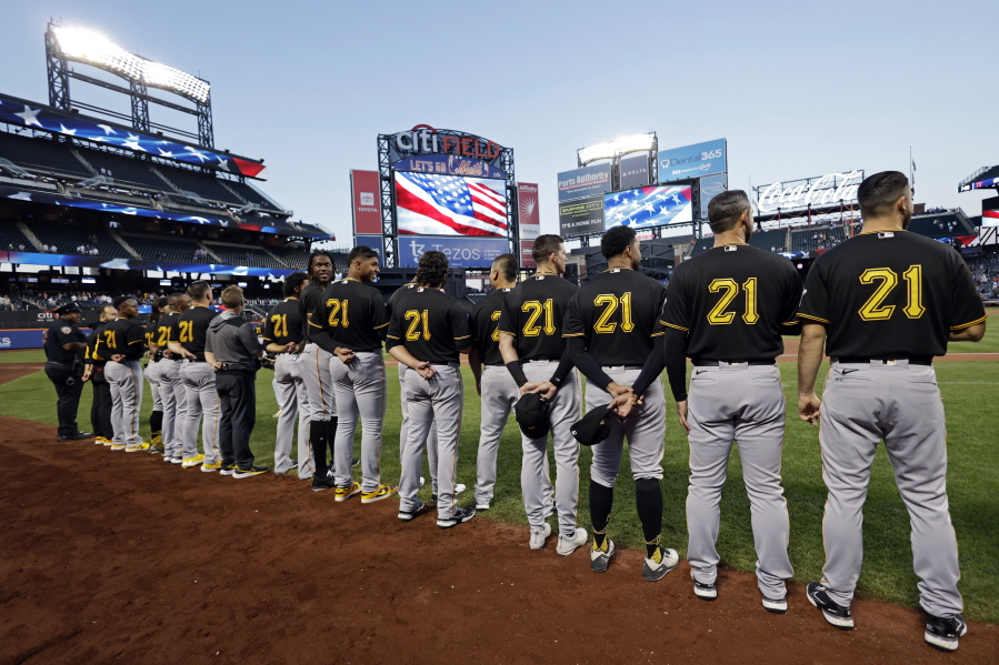 Members of the Pittsburgh Pirates, wearing No. 21 for Roberto Clemente, stand for the national anthem before a baseball game against the New York Mets on Thursday, Sept. 15, 2022, in New York.