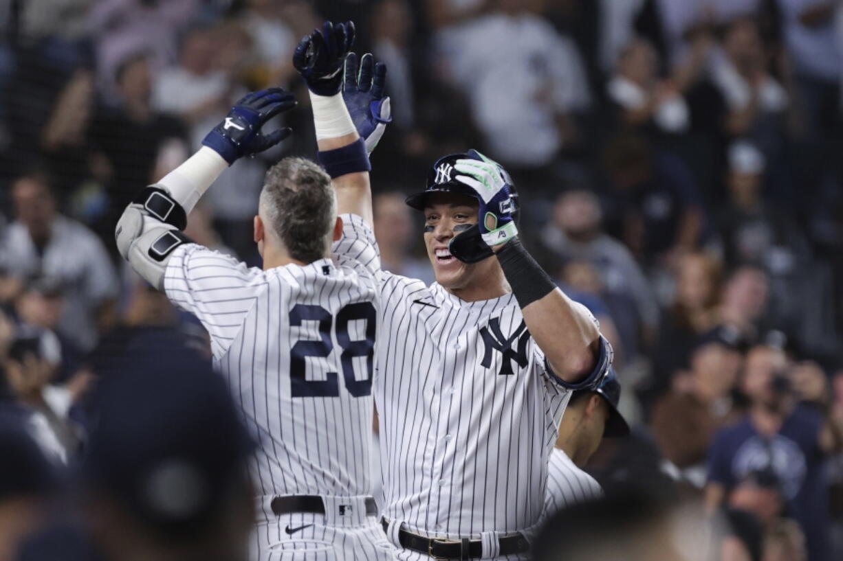 New York Yankees' Aaron Judge celebrates with Josh Donaldson (28) after hitting his 60th home run of the season, during the ninth inning of the team's baseball game against the Pittsburgh Pirates on Tuesday, Sept. 20, 2022, in New York.