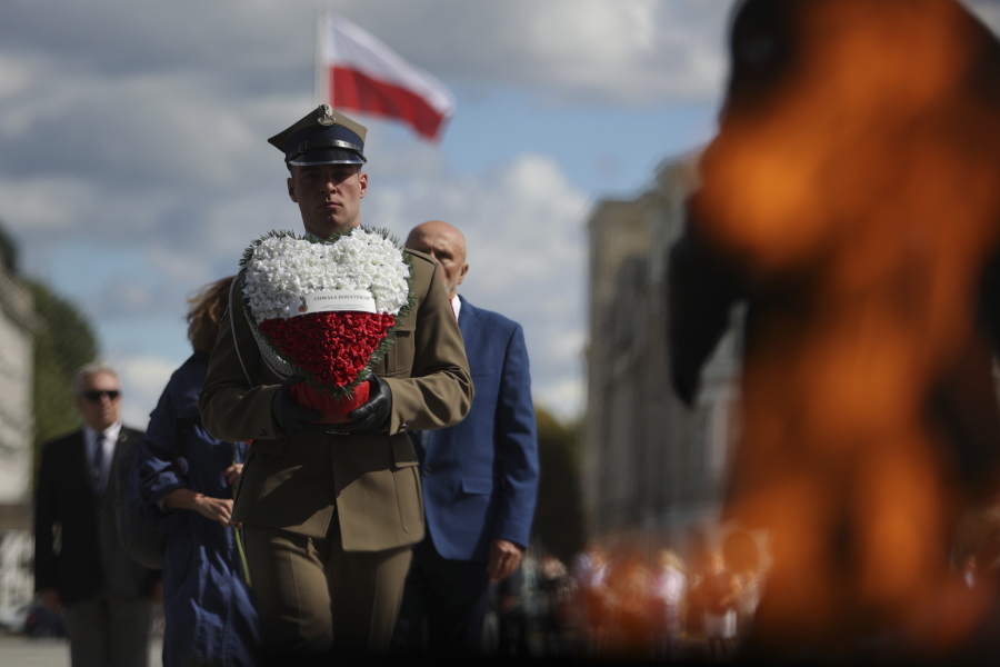A Polish soldier holds a wreath while attending a ceremony marking national observances of the anniversary of World War II in Warsaw, Poland, Sept. 1, 2022. World War II began on Sept. 1, 1939, with Nazi Germany's bombing and invading Poland, for more than five years of brutal occupation.