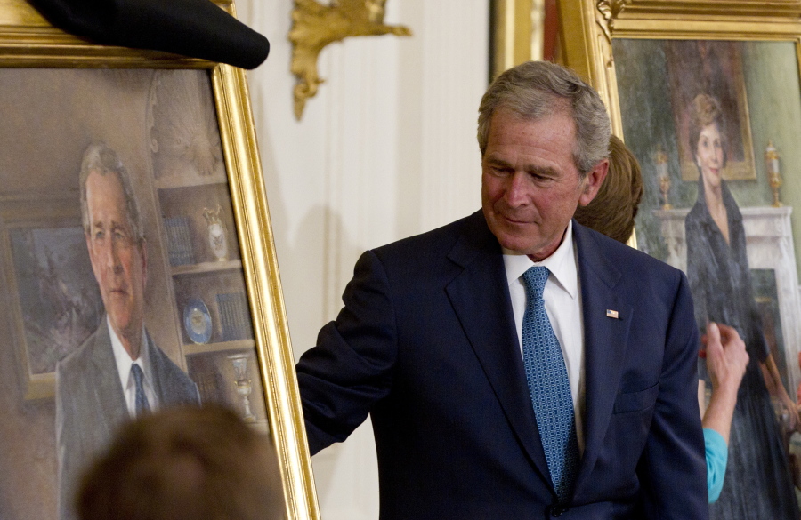 FILE - Former President George W. Bush and former first lady Laura Bush, right, unveil their portraits in the East Room of the White House in Washington, May 31, 2012.