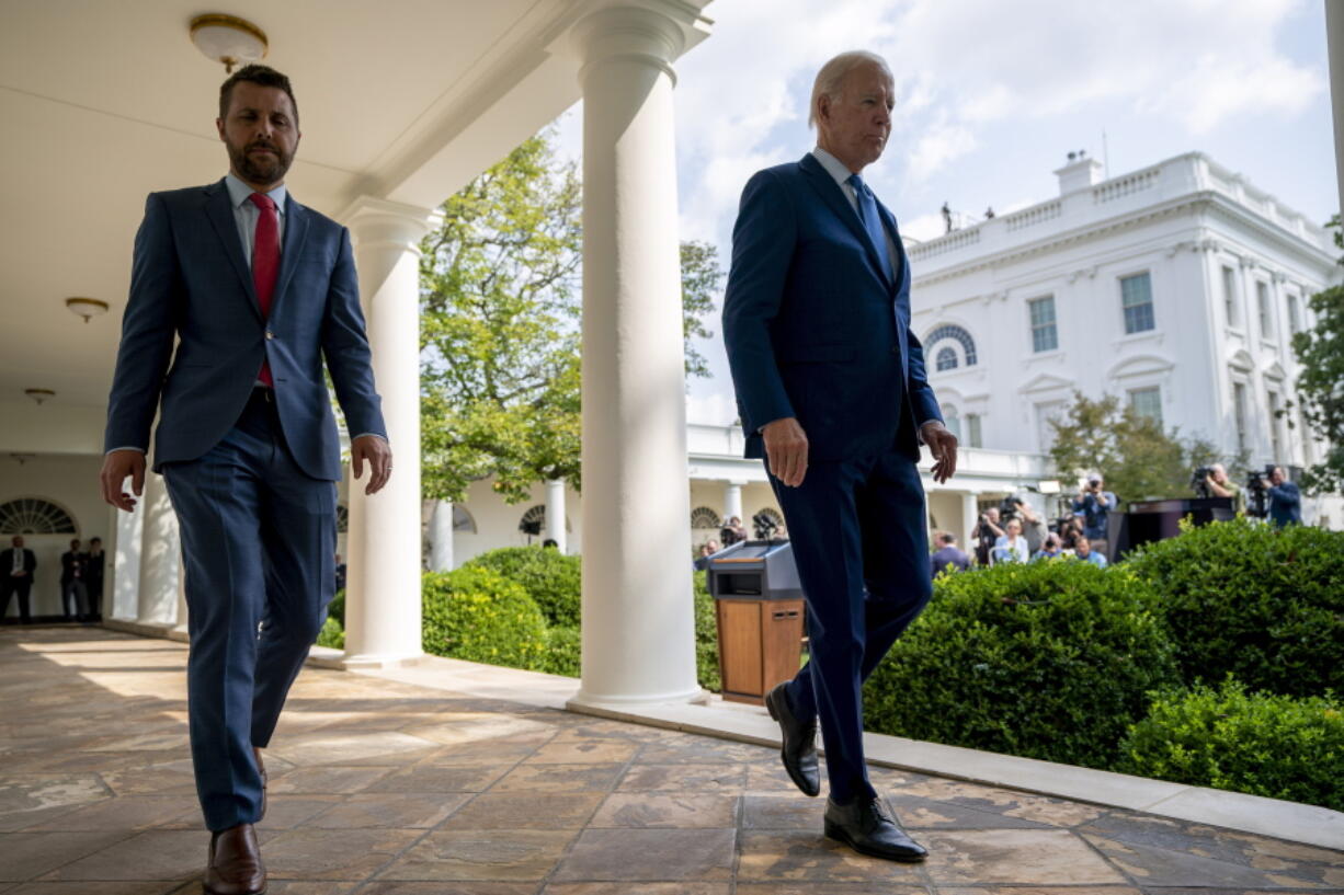 President Joe Biden walks to the Oval Office with National Economic Council director Brian Deese, left, after speaking about a tentative railway labor agreement in the Rose Garden of the White House, Thursday, Sept. 15, 2022, in Washington.