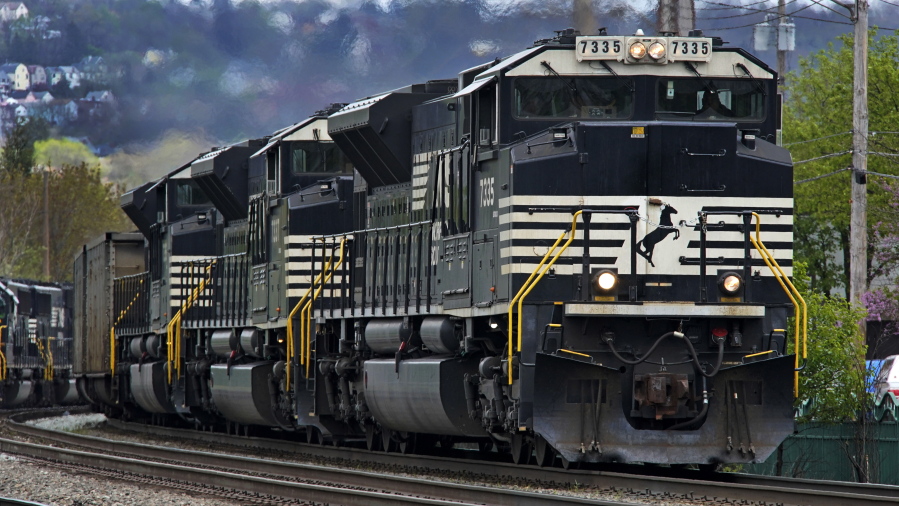 FILE - A Norfolk Southern freight train makes its way through Homestead, Pa., on April 27, 2022. Business and top officials are bracing for the possibility of a nationwide rail strike Friday, Sept. 16, 2022, while talks continue between the nation's largest freight railroads and their unions. (AP Photo/Gene J.