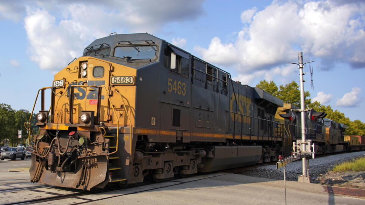 A CSX freight train runs through a crossing in Homestead, Pa., Wednesday, Sept. 14, 2022. (AP Photo/Gene J.
