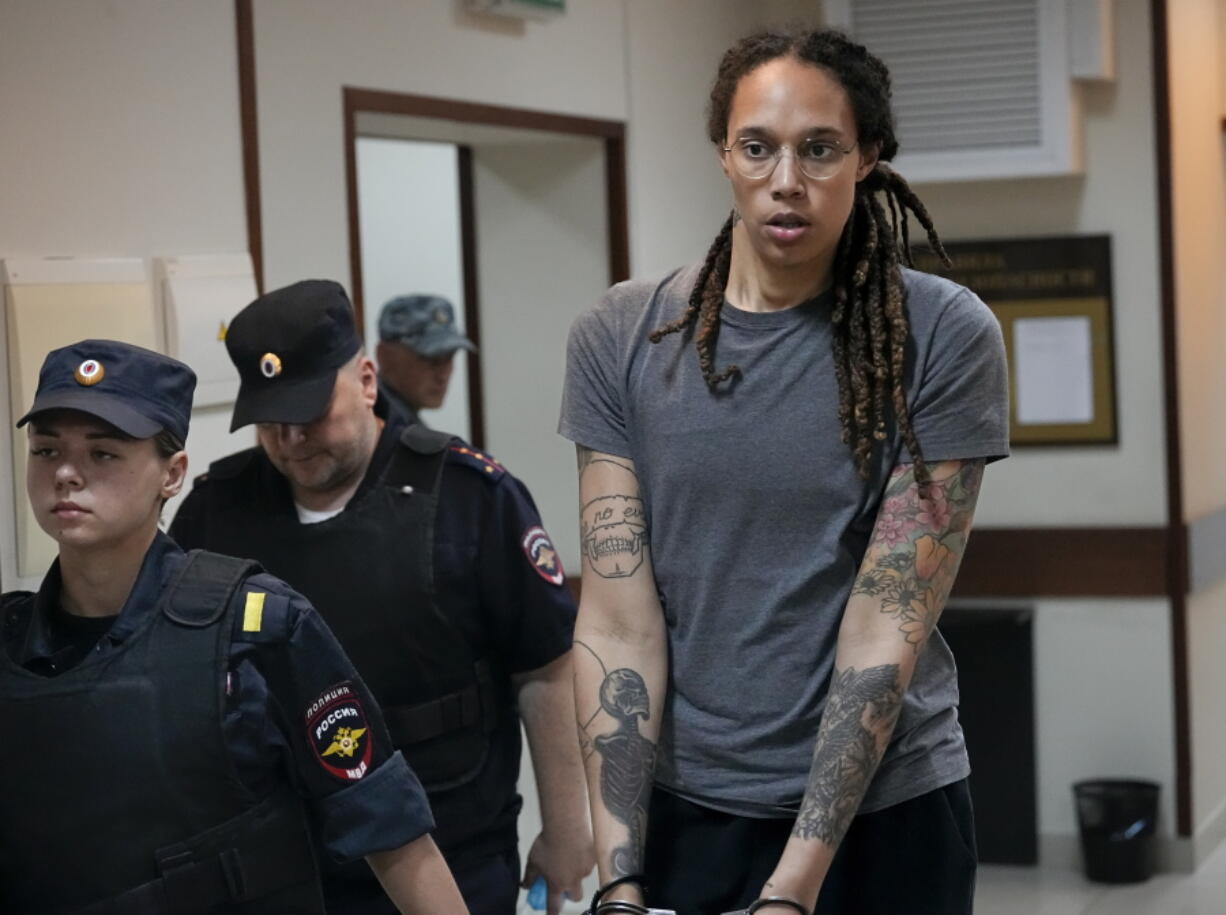 FILE - WNBA star and two-time Olympic gold medalist Brittney Griner is escorted from a court room ater a hearing, in Khimki just outside Moscow, Russia, Aug. 4, 2022. President Joe Biden plans to meet at the White House on Friday, Sept. 16, with family members of Griner and Michigan corporate security executive Paul Whelan, both of whom remain jailed in Russia, senior administration officials told The Associated Press.