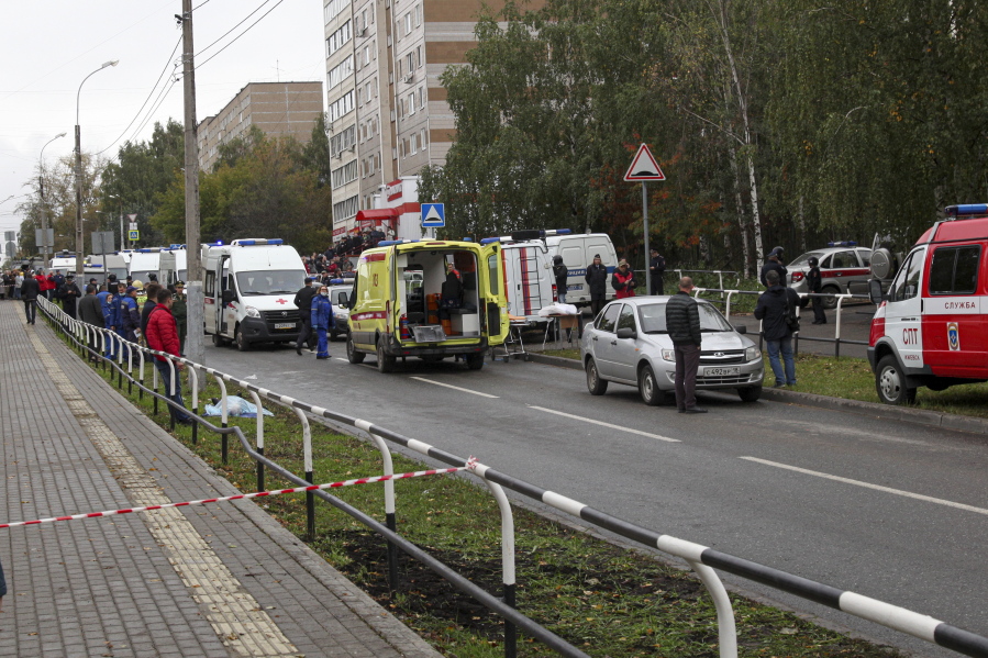 Police and paramedics work at the scene of a shooting at school No. 88 in Izhevsk, Russia, Monday, Sept. 26, 2022. A gunman on Monday morning killed 13 people and wounded 21 others in a school in central Russia, authorities said. Russia's Investigative Committee said in statement that seven children were among those killed in the shooting in the school in Izhevsk, a city about 960 kilometers (596 miles) east of Moscow in the Udmurtia region.