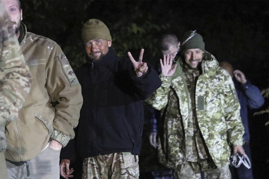 In this photo provided by the Ukrainian Security service Press Office, Ukrainian soldiers, who were released in a prisoner exchange between Russia and Ukraine, smile close to Chernihiv, Ukraine, late Wednesday, Sept. 21, 2022. Ukraine announced a high-profile prisoner swap early Thursday that culminated months of efforts to free many of the Ukrainian fighters who defended a steel plant in Mariupol during a long Russian siege.