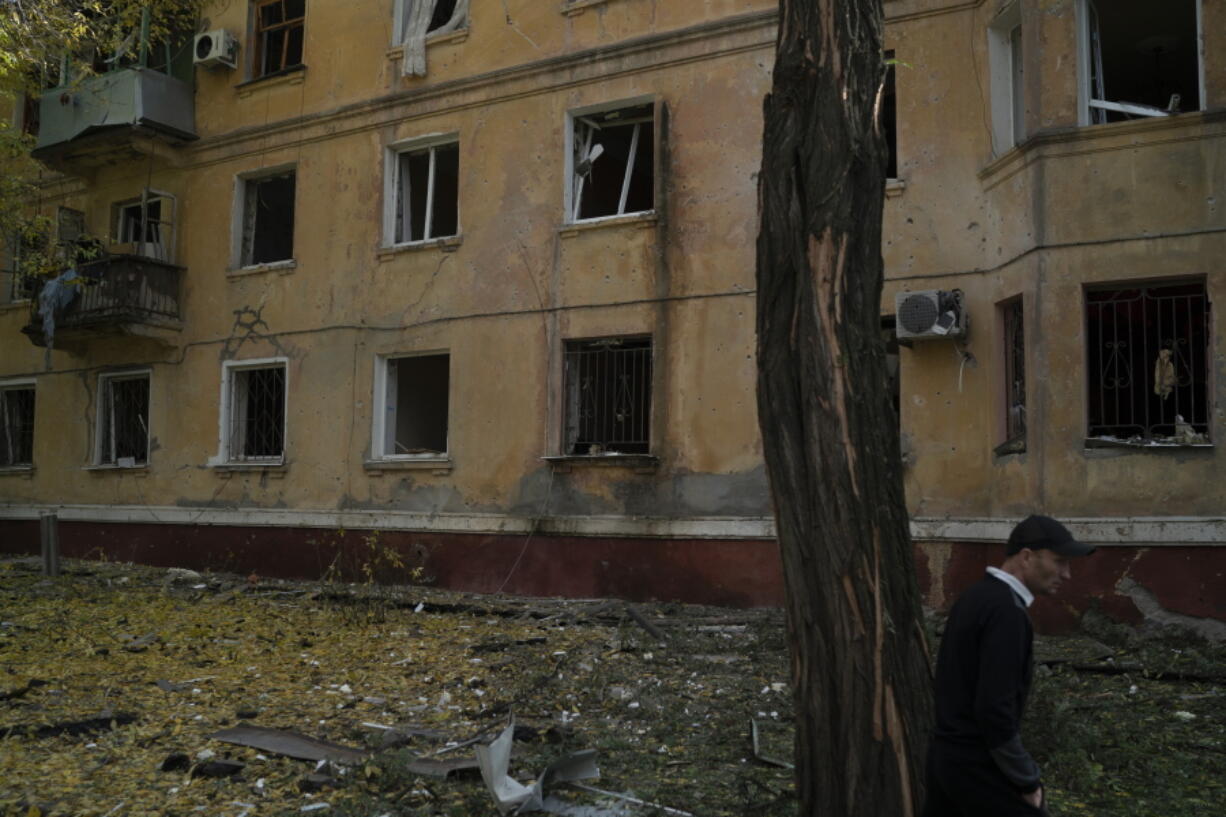A man walks past a damaged building after a Russian attack in Kramatorsk, Ukraine, Thursday, Sept. 29, 2022.