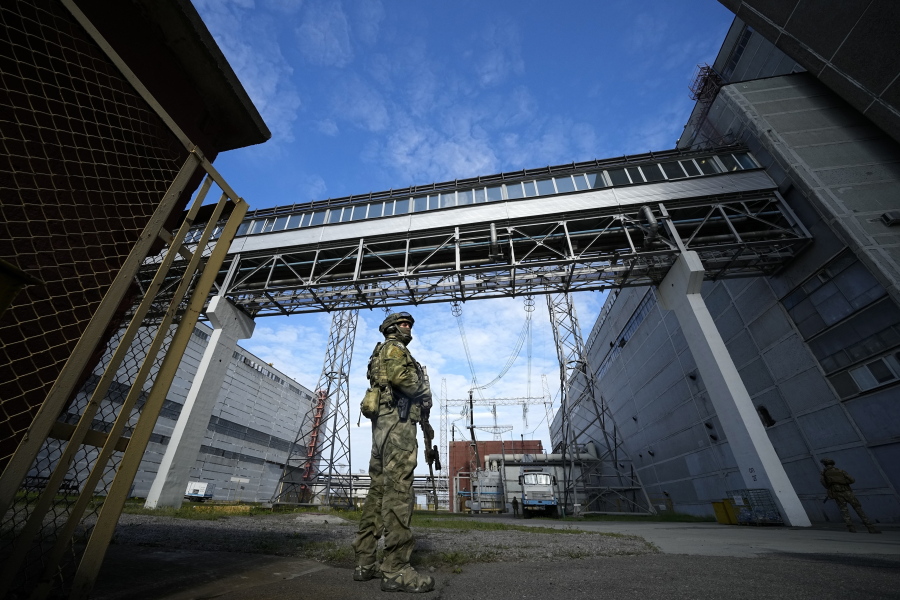 FILE - A Russian serviceman guards an area of the Zaporizhzhia Nuclear Power Station in territory under Russian military control, southeastern Ukraine, May 1, 2022. Ukraine's Zaporizhzhia nuclear power plant , built during the Soviet era and one of the 10 biggest in the world, has been engulfed by fighting between Russian and Ukrainian troops in recent weeks, fueling concerns of a nuclear catastrophe.