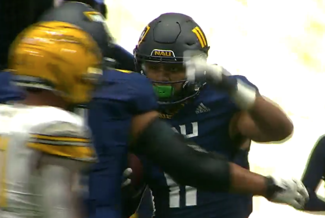 Union High School graduate Alishawuan Taylor celebrates with his Northern Arizona teammates after his first collegiate touchdown on Saturday against Idaho.