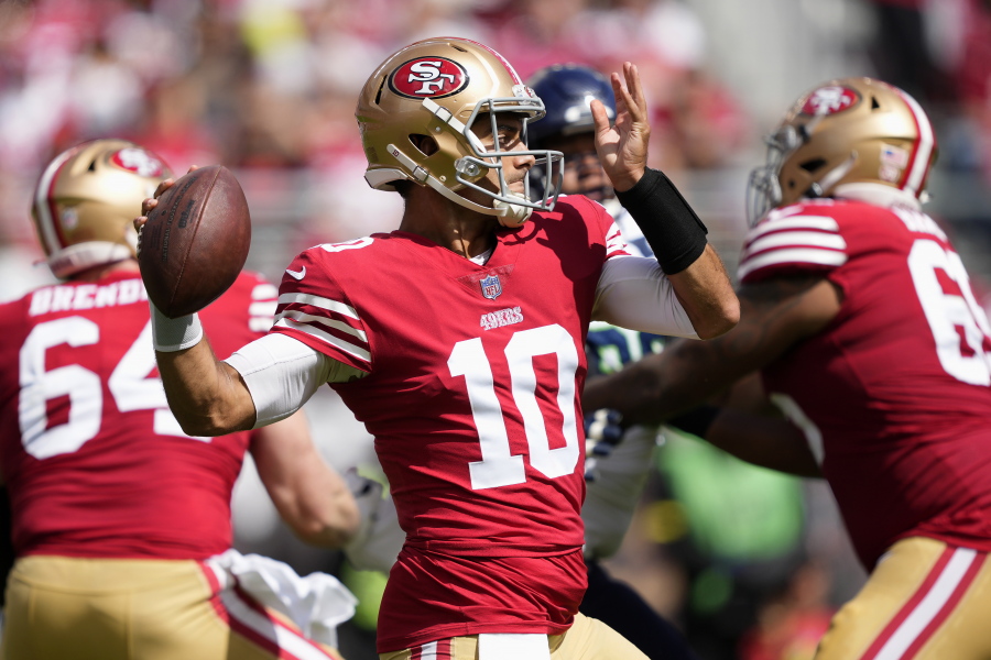 San Francisco 49ers quarterback Jimmy Garoppolo (10) passes against the Seattle Seahawks during the first half of an NFL football game in Santa Clara, Calif., Sunday, Sept. 18, 2022.