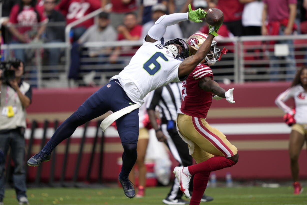 Seattle Seahawks safety Quandre Diggs, left, breaks up a pass intended for San Francisco 49ers wide receiver Danny Gray during the first half of an NFL football game in Santa Clara, Calif., Sunday, Sept. 18, 2022.