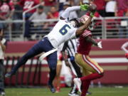 Seattle Seahawks safety Quandre Diggs, left, breaks up a pass intended for San Francisco 49ers wide receiver Danny Gray during the first half of an NFL football game in Santa Clara, Calif., Sunday, Sept. 18, 2022.