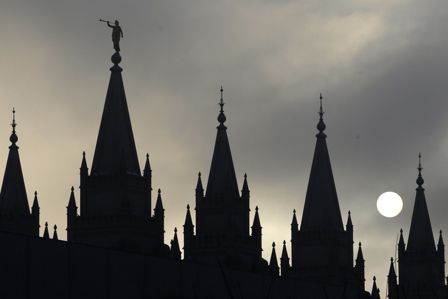 The angel Moroni statue atop the Salt Lake Temple is silhouetted against a cloud-covered sky at Temple Square in Salt Lake City in 2013. The Latter-day Saints have announced plans to build multiple temples in the U.S. — including one in Vancouver.