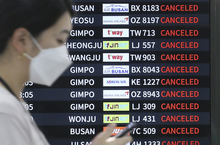 An electronic signboard shows canceled flights as Typhoon Hinnamnor travels toward the Korean Peninsula at Jeju International Airport on Jeju Island, South Korea, Monday, Sept. 5, 2022.