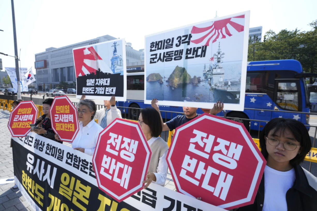 Protesters stage a rally to oppose the joint naval exercises between South Korea, U.S. and Japan in front of the presidential office in Seoul, South Korea, Friday, Sept, 30, 2022. South Korea, U.S. and Japanese warships launched their first anti-submarine drills in five years on Friday, after North renewed ballistic missile tests this week in an apparent response to bilateral training by South Korean and U.S. forces.