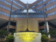 FILE - A cross and Bible sculpture stand outside the Southern Baptist Convention headquarters in Nashville, Tenn., May 24, 2022. On Tuesday, Sept.