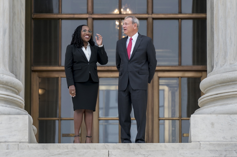 Justice Ketanji Brown Jackson, left, is escorted by Chief Justice of the United States John Roberts following her formal investiture ceremony at the Supreme Court in Washington, Friday, Sept. 30, 2022. (AP Photo/J.