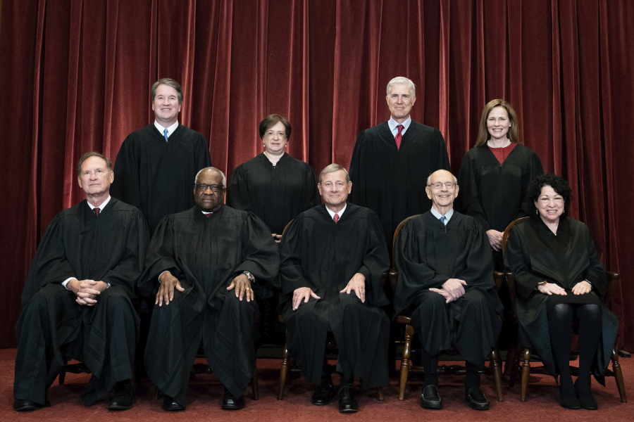 FILE - Members of the Supreme Court pose for a group photo at the Supreme Court in Washington, April 23, 2021. Seated from left are Associate Justice Samuel Alito, Associate Justice Clarence Thomas, Chief Justice John Roberts, Associate Justice Stephen Breyer and Associate Justice Sonia Sotomayor, Standing from left are Associate Justice Brett Kavanaugh, Associate Justice Elena Kagan, Associate Justice Neil Gorsuch and Associate Justice Amy Coney Barrett. The Supreme Court says it will continue providing live audio broadcasts of arguments in cases, even as it welcomes the public back to its courtroom for a new term that begins Monday.