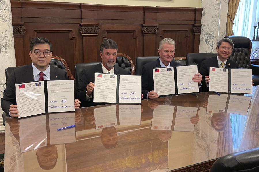 From left, Taiwan Flour Mills Association Chairman Tony Yi-Chuen Shu, Idaho Wheat Commission Chairman Clark Hamilton, Republican Idaho Gov. Brad Little and Director General Daniel K.C. Chen of the Taipei Economic and Cultural Office in Seattle display signed copies of the two-year wheat trade agreement at the Statehouse in Boise, Idaho, on Monday, Sept. 19, 2022. Officials say Monday's agreement solidifies the commitment that allows Idaho to benefit economically and gives Taiwan a dependable supplier.