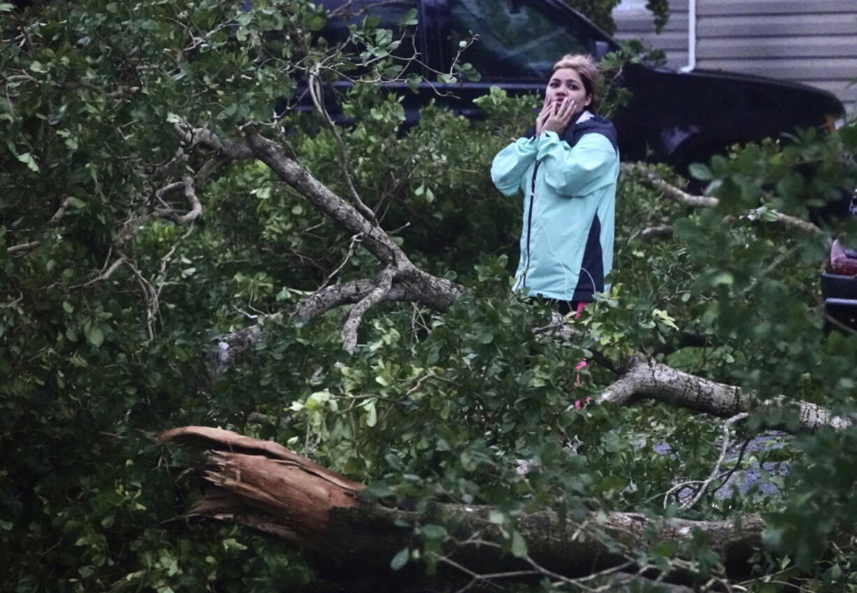 Zuram Rodriguez surveys the damage around her mobile home in Davie, Fla., early Wednesday, Sept. 28, 2022. Hurricane Ian rapidly intensified off Florida's southwest coast Wednesday morning, gaining top winds of 155 mph (250 kph), just shy of the most dangerous Category 5 status.