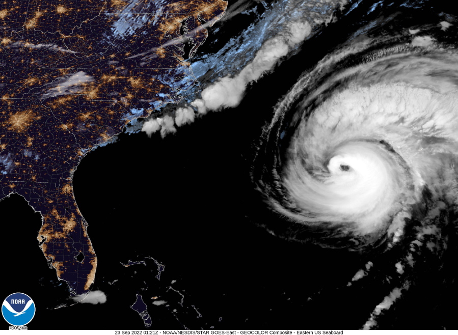 This image provided by the National Hurricane Center National Oceanic and Atmospheric Administration shows a satellite view as Hurricane Fiona moves up the United States Atlantic coast, Thursday night, Sept. 22, 2022. Hurricane Fiona pounded Bermuda with heavy rains and winds as it swept by the island on a route that has it reaching northeastern Canada as a still-powerful storm late Friday.