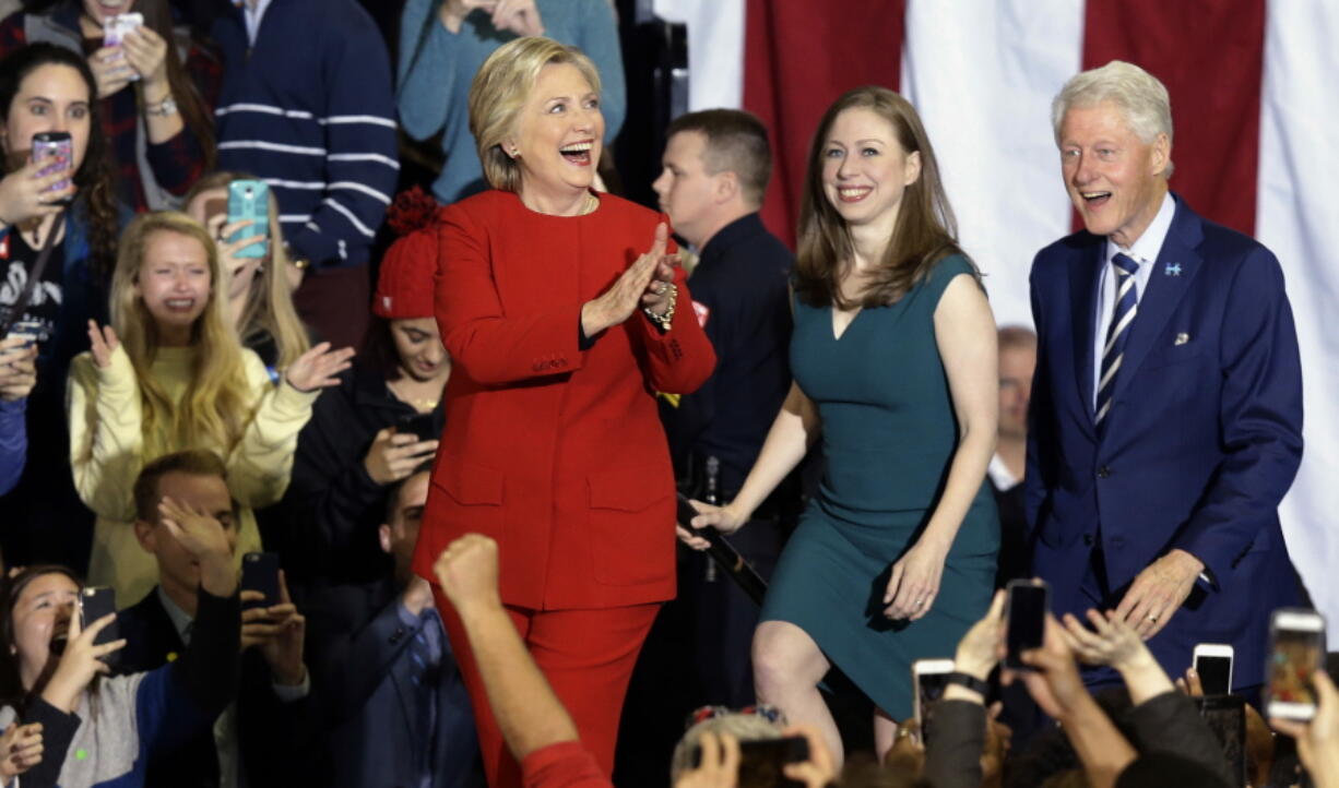 FILE - Democratic presidential candidate Hillary Clinton is joined by daughter Chelsea Clinton and husband, former President Bill Clinton, during a late-night campaign rally at North Carolina State University in Raleigh, N.C., Tuesday, Nov. 8, 2016. The first Clinton Global Initiative since 2016 is set to kick off Monday, Sept. 19, 2022, in New York City, with top international leaders from politics, business, and philanthropy set to attend and collaborate to tackle world issues.