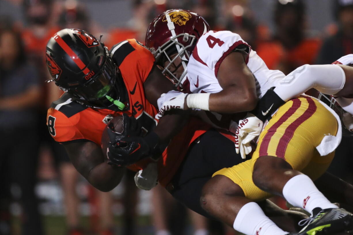 Oregon State running back Jam Griffin is brought down by Southern California defensive back Max Williams during the first half of an NCAA college football game Saturday, Sept. 24, 2022, in Corvallis, Ore.