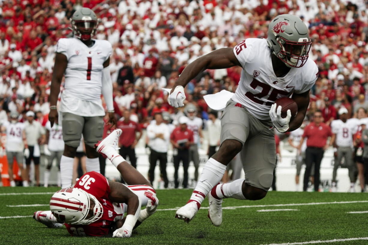 Washington State's Nakia Watson (25) runs past Wisconsin's Jake Chaney (36) during the first half of an NCAA college football game Saturday, Sept. 10, 2022, in Madison, Wis.