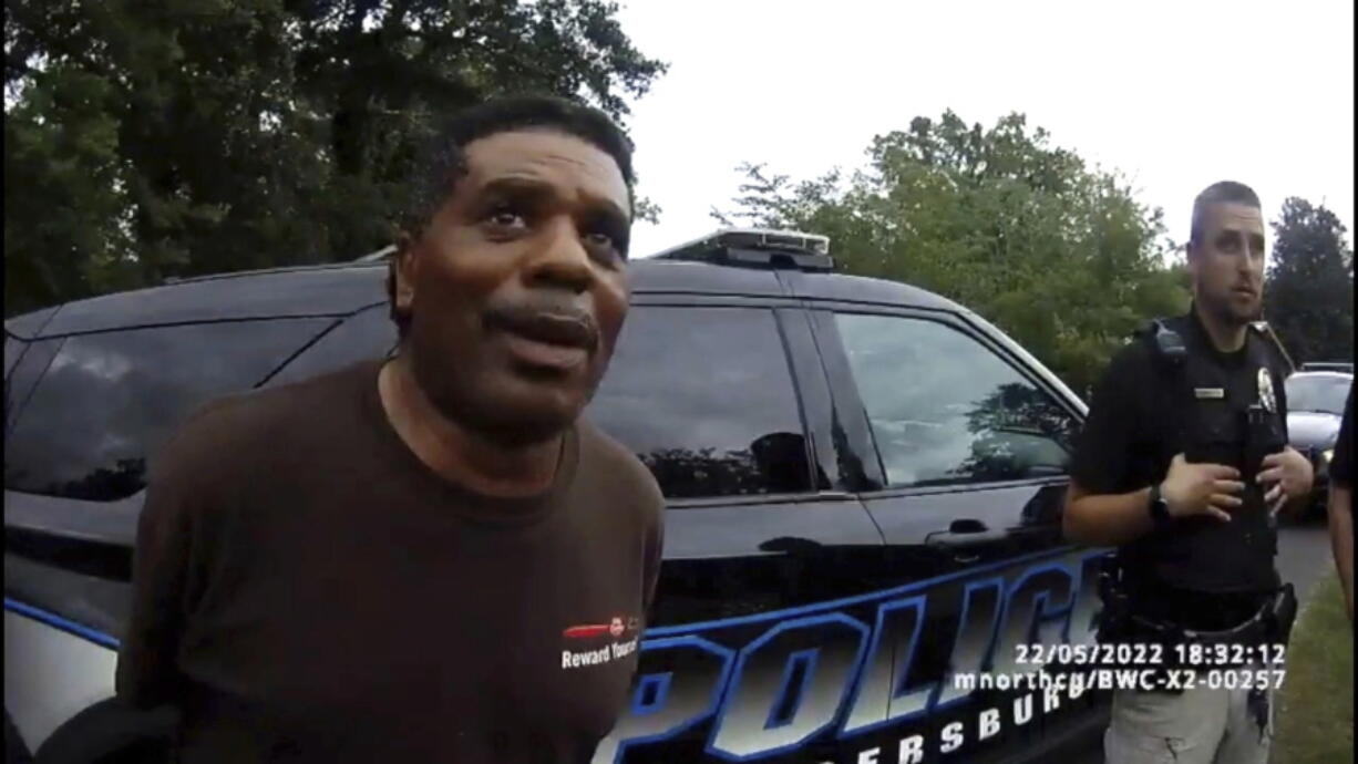 This image captured from bodycam video released by the Childersburg (Ala.) Police Department and provided by attorney Harry Daniels shows Michael Jennings, left, in custody in Childersburg, Ala., on Sunday, May 22, 2022. Jennings was helping out a friend by watering flowers when officers showed up and placed him under arrest within moments.
