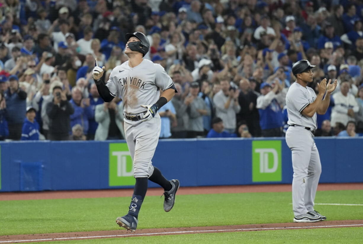 New York Yankees' Aaron Judge celebrates his 61st home run of the season, a two-run shot against the Toronto Blue Jays during the seventh inning of a baseball game Wednesday, Sept. 28, 2022, in Toronto.