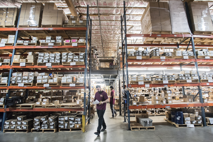 Warehouse Manager Lucas Salazr, left, and warehouse worker Chase Campbell, right, fill orders at Vancouver Bolt & Supply in 2019.  Demand for warehouse space like this supply company's have increased in recent years.