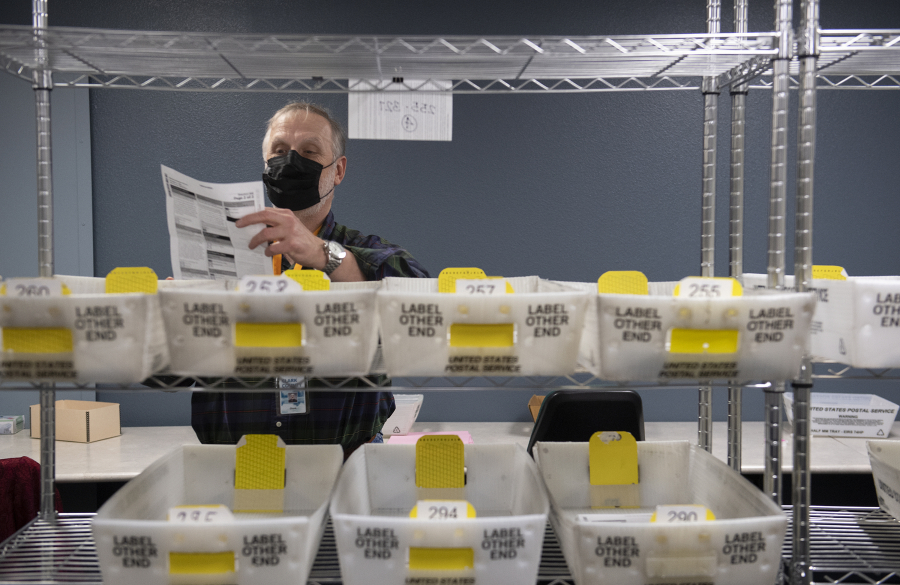 Election board worker Chuck Perine prepares ballots to be recounted at the Clark County Elections Office on Nov. 29, 2021.