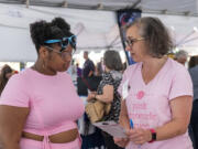 Pink Lemonade Project CEO Susan Stearns, right, talks with Portland resident Nicole Bell on Sept. 8 at The Standard Volunteer Expo at Pioneer Courthouse Square in Portland. The nonprofit is trying to recruit more volunteers and raise its profile.