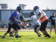 Washington School for the Deaf players practice Tuesday, Oct. 4, 2022, at the WSD football field in Vancouver. Some of the state's smaller 1B schools are transitioning to 6-man football, including Washington School for the Deaf.