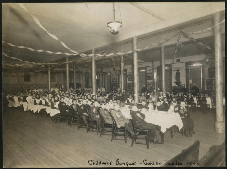 Children in the Providence Academy auditorium (today's remodeled ballroom) celebrate the 1906 Golden Jubilee of the first arrival of the Sisters of Providence here.