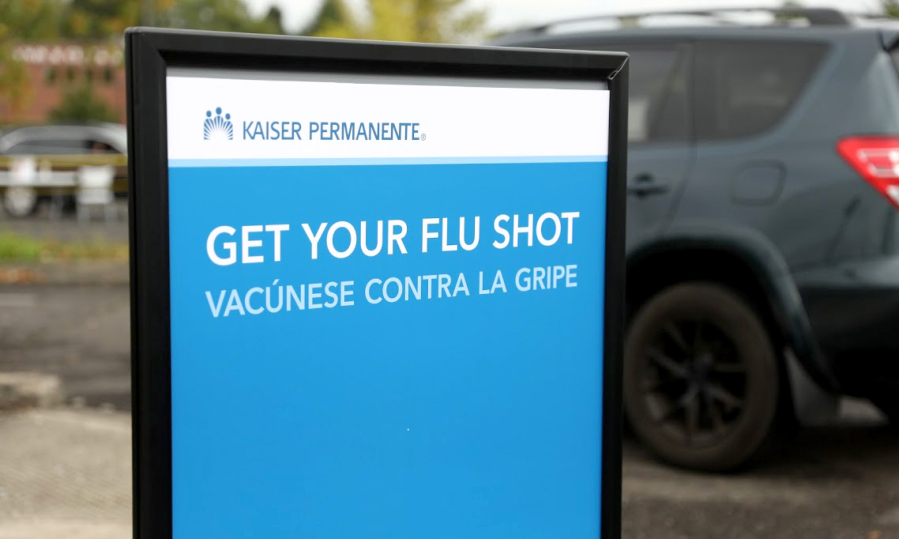 A sign urges people to get a flu shot at Kaiser Permanente.