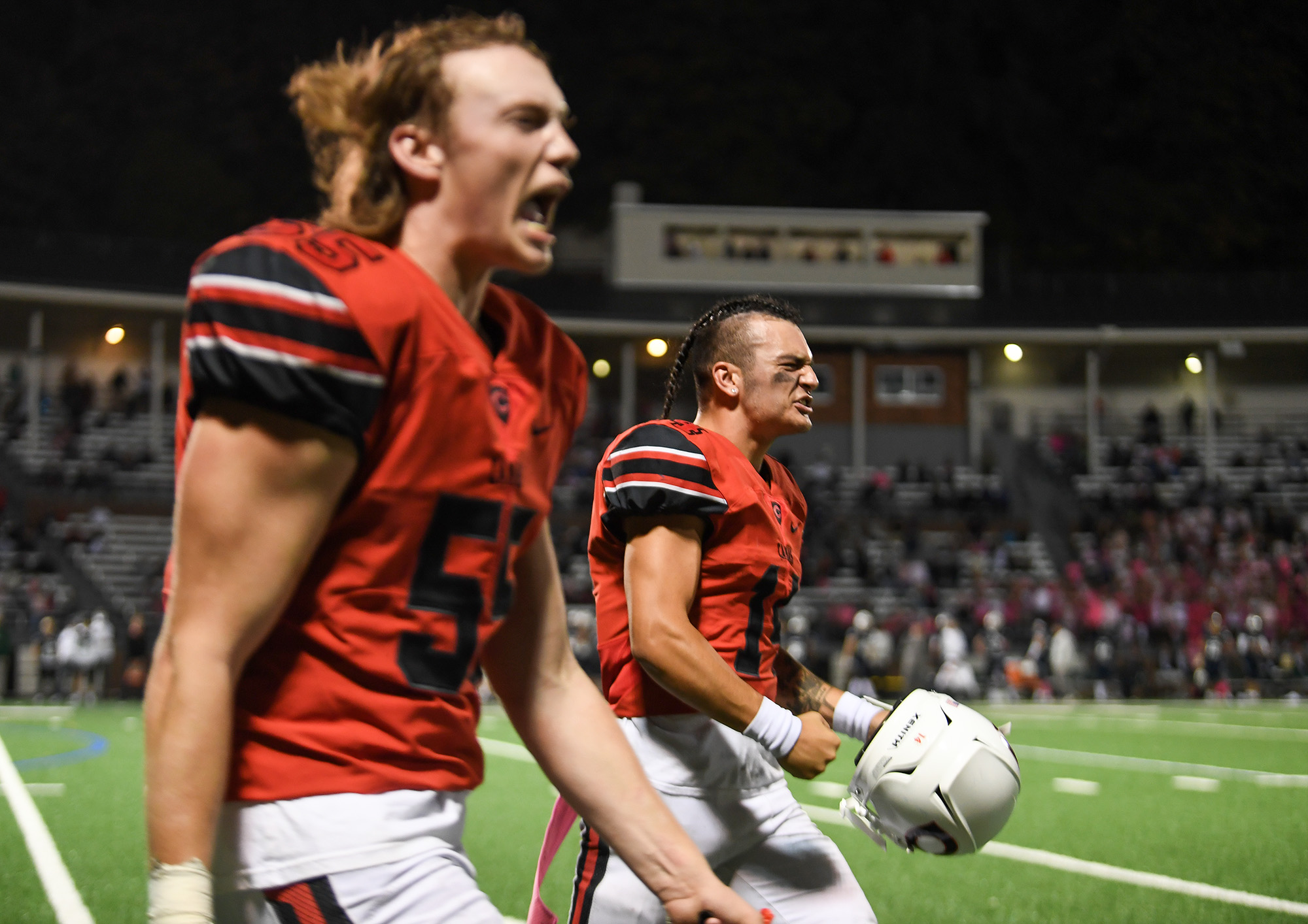 Camas senior Taylor Ioane, right, and junior Marc Jackson celebrate Friday, Oct. 14, 2022, during the Papermakers’ 36-33 win against Skyview at Kiggins Bowl.