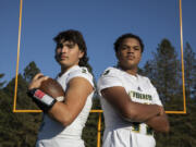 Evergreen quarterbacks Jayden Crace, left, and Khalil Osbin pause for a portrait during football practice at Evergreen High School on Tuesday, October 12, 2022.