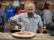 Darin Kyle of Quartz Mountain Distillers pours a sample of bourbon while taking a break at his Vancouver-area distillery earlier this month.