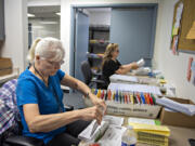 Election workers Juanita Berry, left, and Valerie Vance gear up for the upcoming election at the Clark County Elections Office on Thursday afternoon. Ballots were due to be mailed Friday to approximately 325,000 registered voters.