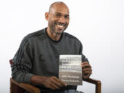 Darius Roberts poses with a copy of his first book, "The 8 Steps to Freedom from Social Media Addiction." Roberts, who grew up in Vancouver, said the inspiration for the book stemmed from his own experience finding himself attached to Facebook.