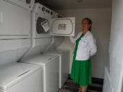 Friends of the Carpenter Board President Wendy Wright displays a dryer in a new laundry trailer at the organization's west Vancouver workshop. The washers and dryers will be open to those in need for free use as soon they're connected to electricity.
